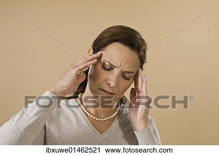 Stock Image - Woman with a severe headache. Fotosearch
