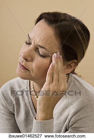 Woman with a severe headache View Large Photo Image Stock Photo - Woman with a severe headache. Fotosearch