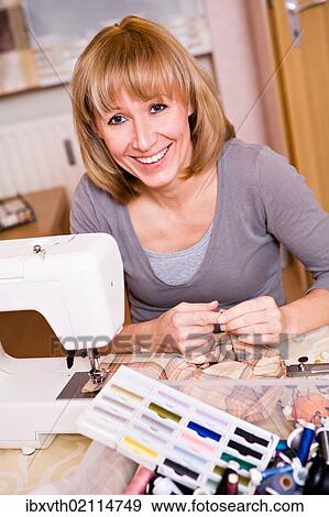 Woman with a sewing machine View Large Photo Image Stock Photo - Woman with a sewing machine. Fotosearch