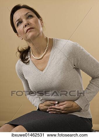 Woman with abdominal pain View Large Photo Image Stock Image - Woman with abdominal pain. Fotosearch