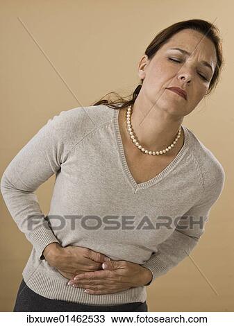 Woman with abdominal pain View Large Photo Image Stock Image - Woman with abdominal pain. Fotosearch