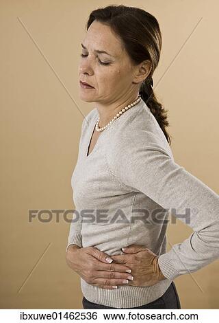 Woman with abdominal pain View Large Photo Image Stock Photograph - Woman with abdominal pain. Fotosearch