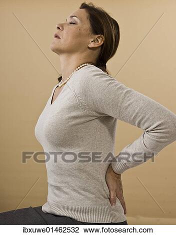 Stock Image - Woman with backache. Fotosearch
