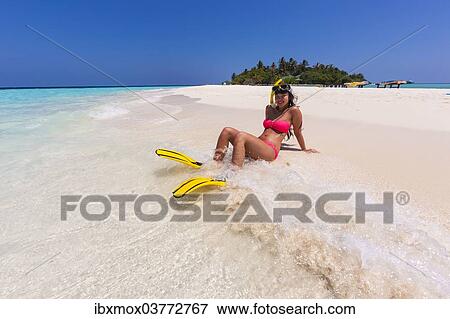 "Woman with flippers and diving goggles sitting on a sand bank, Indian Ocean, Maldives, Asia" View Large Photo Image Stock Photo - "Woman with flippers and diving goggles sitting on a sand bank, Indian Ocean, Maldives, Asia". Fotosearch