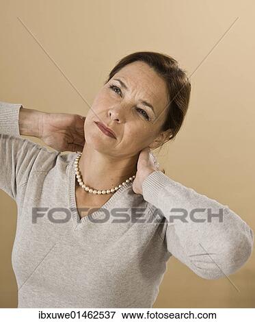 Stock Photo - Woman with neck pain. Fotosearch