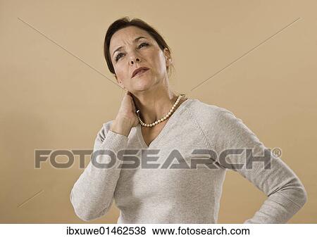 Woman with neck pain View Large Photo Image Stock Photo - Woman with neck pain. Fotosearch