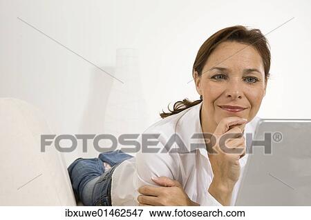 Woman working on a laptop View Large Photo Image Stock Photo - Woman working on a laptop. Fotosearch
