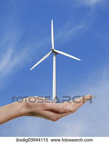 Woman's hand holding a wind turbine against a blue sky View Large Photo Image Stock Photography - Woman's hand holding a wind turbine against a blue sky. Fotosearch