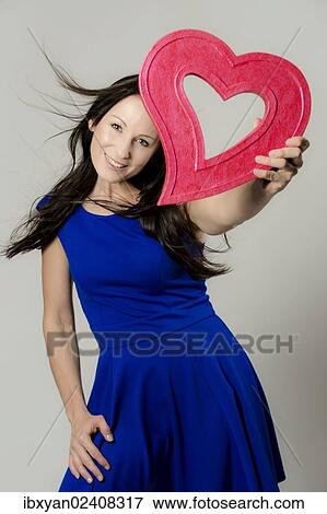 Women holding a heart View Large Photo Image Stock Photo - Women holding a heart. Fotosearch