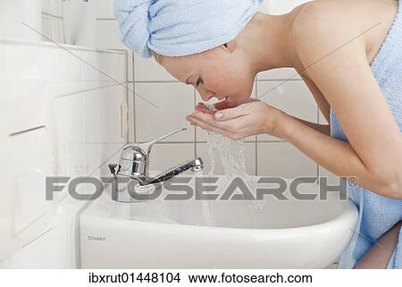 Women washing her face with water View Large Photo Image Picture - Women washing her face with water. Fotosearch