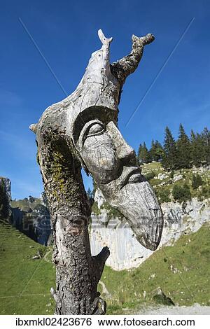 "Woodcarving on an old tree trunk in the Appenzell Alps, canton of Appenzell Inner-Rhodes, Switzerland, Europe" View Large Photo Image Stock Photograph - "Woodcarving on an old tree trunk in the Appenzell Alps, canton of Appenzell Inner-Rhodes, Switzerland, Europe". Fotosearch