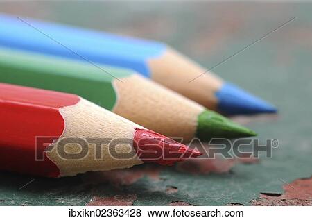 "Wooden coloured pencils, red, green and blue on an old wooden board" View Large Photo Image Stock Photo - "Wooden coloured pencils, red, green and blue on an old wooden board". Fotosearch