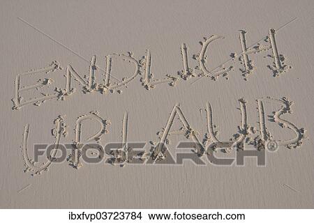 "Writing in the sand """"endlich Urlaub"""", German for """"finally holidays""""" View Large Photo Image Picture - "Writing in the sand """"endlich Urlaub"""", German for """"finally holidays""""". Fotosearch