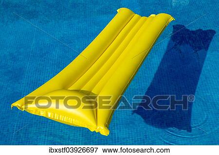 "Yellow lilo, in a swimming pool" View Large Photo Image Stock Photo - "Yellow lilo, in a swimming pool". Fotosearch