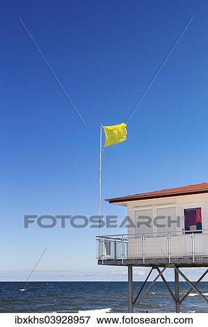 "Yellow warning flag at a DLRG hut, German Life Saving Association, on a Baltic Sea beach, Usedom, Mecklenburg-Western Pomerania, Germany, Europe" View Large Photo Image Stock Photo - "Yellow warning flag at a DLRG hut, German Life Saving Association, on a Baltic Sea beach, Usedom, Mecklenburg-Western Pomerania, Germany, Europe". Fotosearch