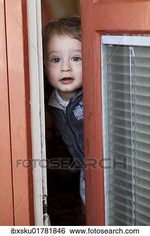 "Young boy, 18 months, looking through a partially opened door" View Large Photo Image Stock Photograph - "Young boy, 18 months, looking through a partially opened door". Fotosearch