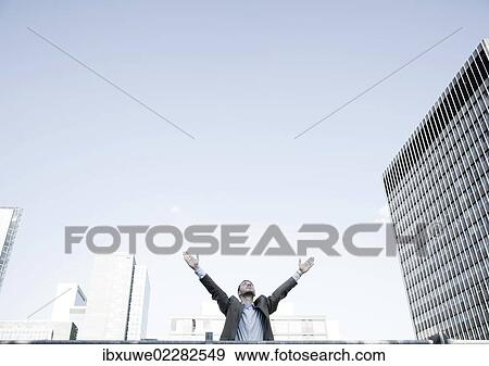 Young businessman happily spreading out his arms View Large Photo Image Stock Photo - Young businessman happily spreading out his arms. Fotosearch