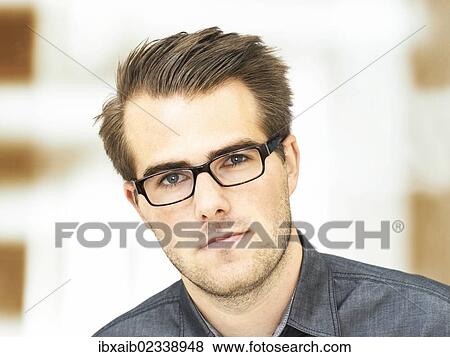 "Young businessman wearing glasses, portrait, serious face" View Large Photo Image Stock Photo - "Young businessman wearing glasses, portrait, serious face". Fotosearch
