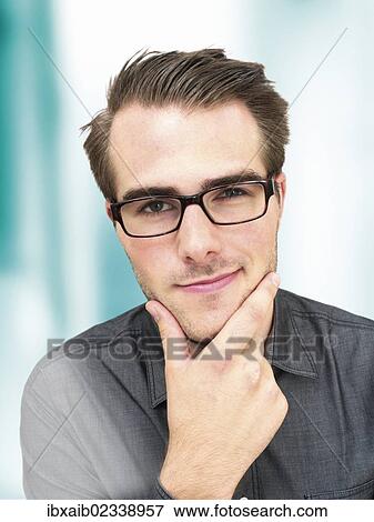 "Young businessman wearing glasses, portrait, sly glance" View Large Photo Image Stock Photo - "Young businessman wearing glasses, portrait, sly glance". Fotosearch