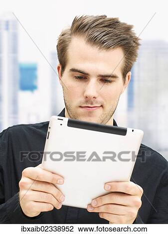 Young businessman with a digital tablet View Large Photo Image Stock Image - Young businessman with a digital tablet. Fotosearch