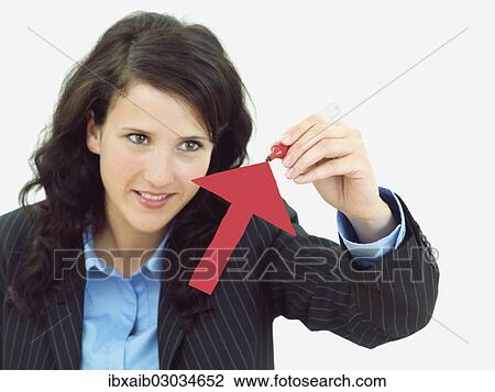 "Young businesswoman drawing an arrow pointing upwards, recovery" View Large Photo Image Stock Image - "Young businesswoman drawing an arrow pointing upwards, recovery". Fotosearch