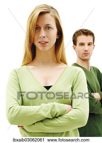 "Young couple standing with their arms crossed, relationship" View Large Photo Image Stock Image - "Young couple standing with their arms crossed, relationship". Fotosearch
