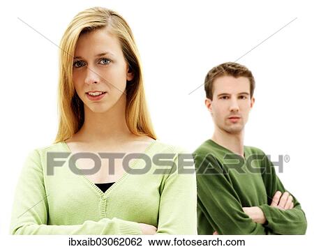 "Young couple standing with their arms crossed, relationship" View Large Photo Image Stock Image - "Young couple standing with their arms crossed, relationship". Fotosearch