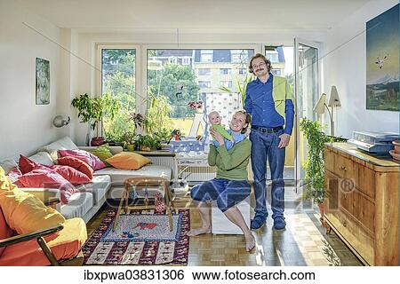 Stock Photograph - Young family in their living room. Fotosearch