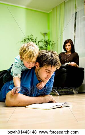 Stock Photo - Young family reading. Fotosearch