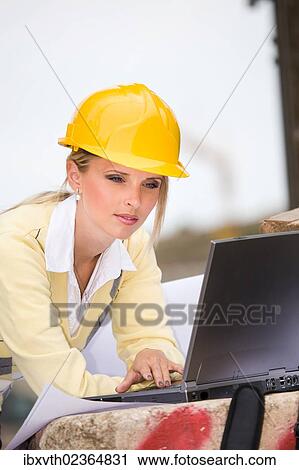 Young female constructor at building site View Large Photo Image Stock Image - Young female constructor at building site. Fotosearch