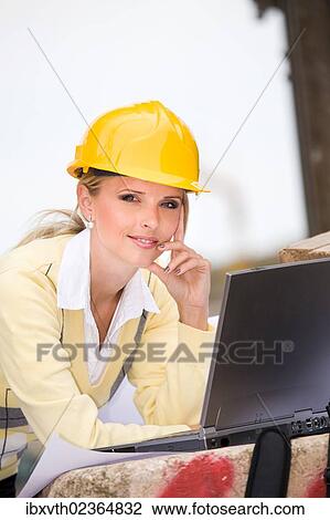 Young female constructor at building site View Large Photo Image Stock Image - Young female constructor at building site. Fotosearch