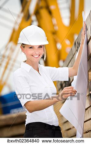 Young female constructor at building site View Large Photo Image Stock Image - Young female constructor at building site. Fotosearch