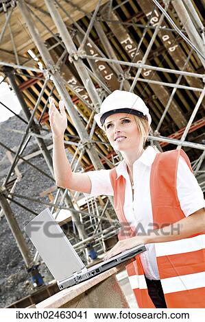 "Young female constructor at building site of a new motorway, Germany, Europe" View Large Photo Image Stock Image - "Young female constructor at building site of a new motorway, Germany, Europe". Fotosearch