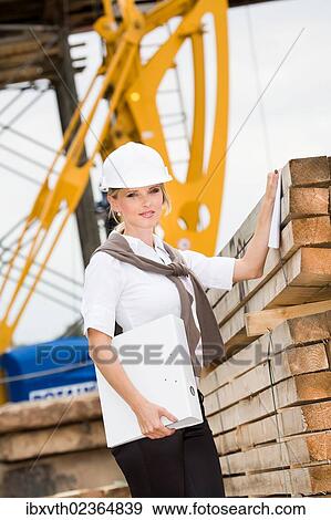Young female constructor at building site View Large Photo Image Stock Photo - Young female constructor at building site. Fotosearch