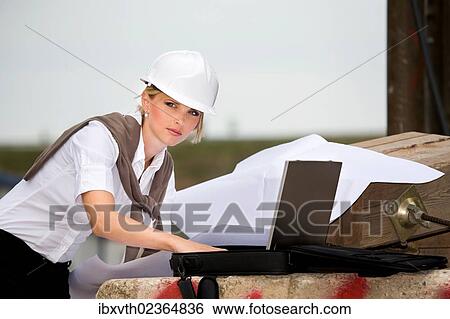 Stock Photograph - Young female constructor at building site. Fotosearch