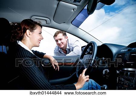 Young female driver being approached by a man View Large Photo Image Picture - Young female driver being approached by a man. Fotosearch