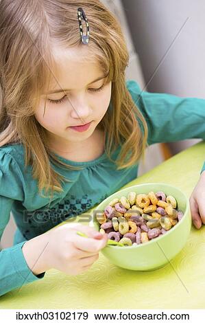 "young girl eating cornflakes from the bowl, Germany, Europe" View Large Photo Image Stock Photo - "young girl eating cornflakes from the bowl, Germany, Europe". Fotosearch