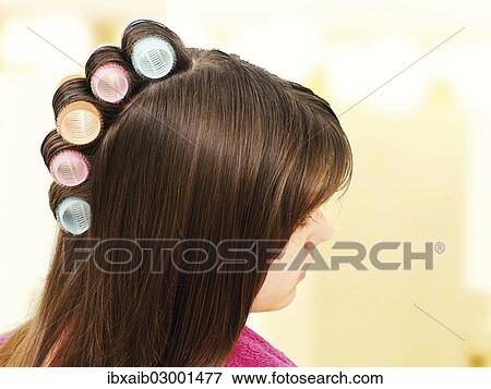 Stock Photo - Young girl with curlers in her hair. Fotosearch