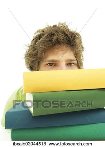 Stock Photo - Young male student with a stack of books. Fotosearch