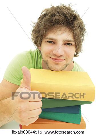 Young male student with a stack of books making a thumbs up gesture View Large Photo Image Stock Photography - Young male student with a stack of books making a thumbs up gesture. Fotosearch