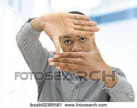 "Young man, African-American, American, his hands shaping a rectangle in front of his face, gesture" View Large Photo Image Stock Image - "Young man, African-American, American, his hands shaping a rectangle in front of his face, gesture". Fotosearch