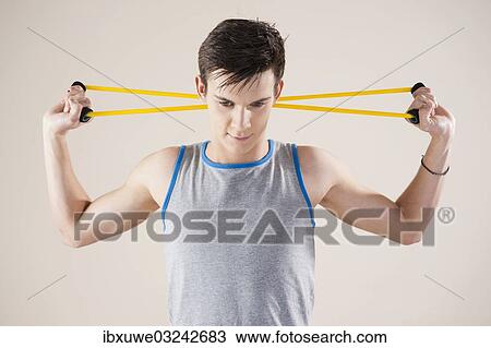 "Young man doing fitness exercises with an expander, Mannheim, Baden-Wurttemberg, Germany, Europe" View Large Photo Image Stock Image - "Young man doing fitness exercises with an expander, Mannheim, Baden-Wurttemberg, Germany, Europe". Fotosearch
