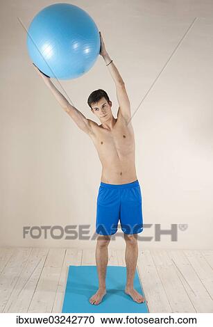 Stock Image - "Young man doing stabilization exercises, Mannheim, Baden-Wurttemberg, Germany, Europe". Fotosearch