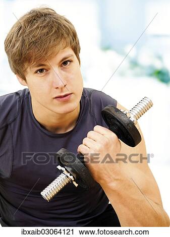 Young man doing strength training with a dumbbell View Large Photo Image Stock Image - Young man doing strength training with a dumbbell. Fotosearch