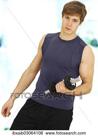 "Young man doing strength training with a dumbbell, muscular" View Large Photo Image Stock Photo - "Young man doing strength training with a dumbbell, muscular". Fotosearch