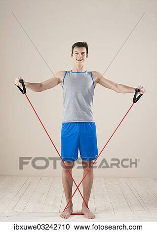 "Young man doing strengthening and stretching exercises with a rubber rope, Mannheim, Baden-Wurttemberg, Germany, Europe" View Large Photo Image Stock Image - "Young man doing strengthening and stretching exercises with a rubber rope, Mannheim, Baden-Wurttemberg, Germany, Europe". Fotosearch
