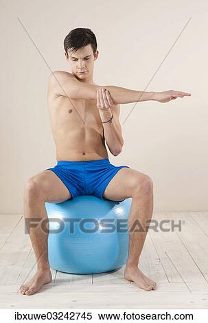 "Young man doing stretching exercises, Mannheim, Baden-Wurttemberg, Germany, Europe" View Large Photo Image Stock Photography - "Young man doing stretching exercises, Mannheim, Baden-Wurttemberg, Germany, Europe". Fotosearch