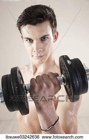 "Young man doing weight training with dumbbells, Mannheim, Baden-Wurttemberg, Germany, Europe" View Large Photo Image Stock Photograph - "Young man doing weight training with dumbbells, Mannheim, Baden-Wurttemberg, Germany, Europe". Fotosearch