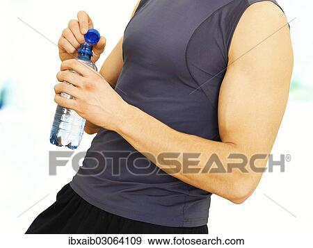 "Young man during training, muscular, opening a water bottle" View Large Photo Image Stock Photo - "Young man during training, muscular, opening a water bottle". Fotosearch