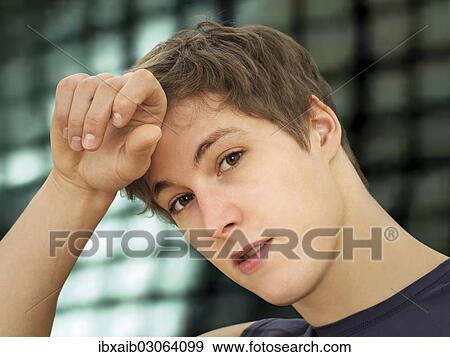 "Young man during training, wiping sweat from his brow" View Large Photo Image Stock Photo - "Young man during training, wiping sweat from his brow". Fotosearch